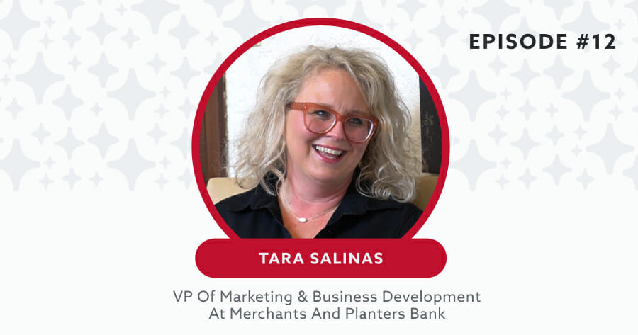 headshot of business woman with red glasses smiling