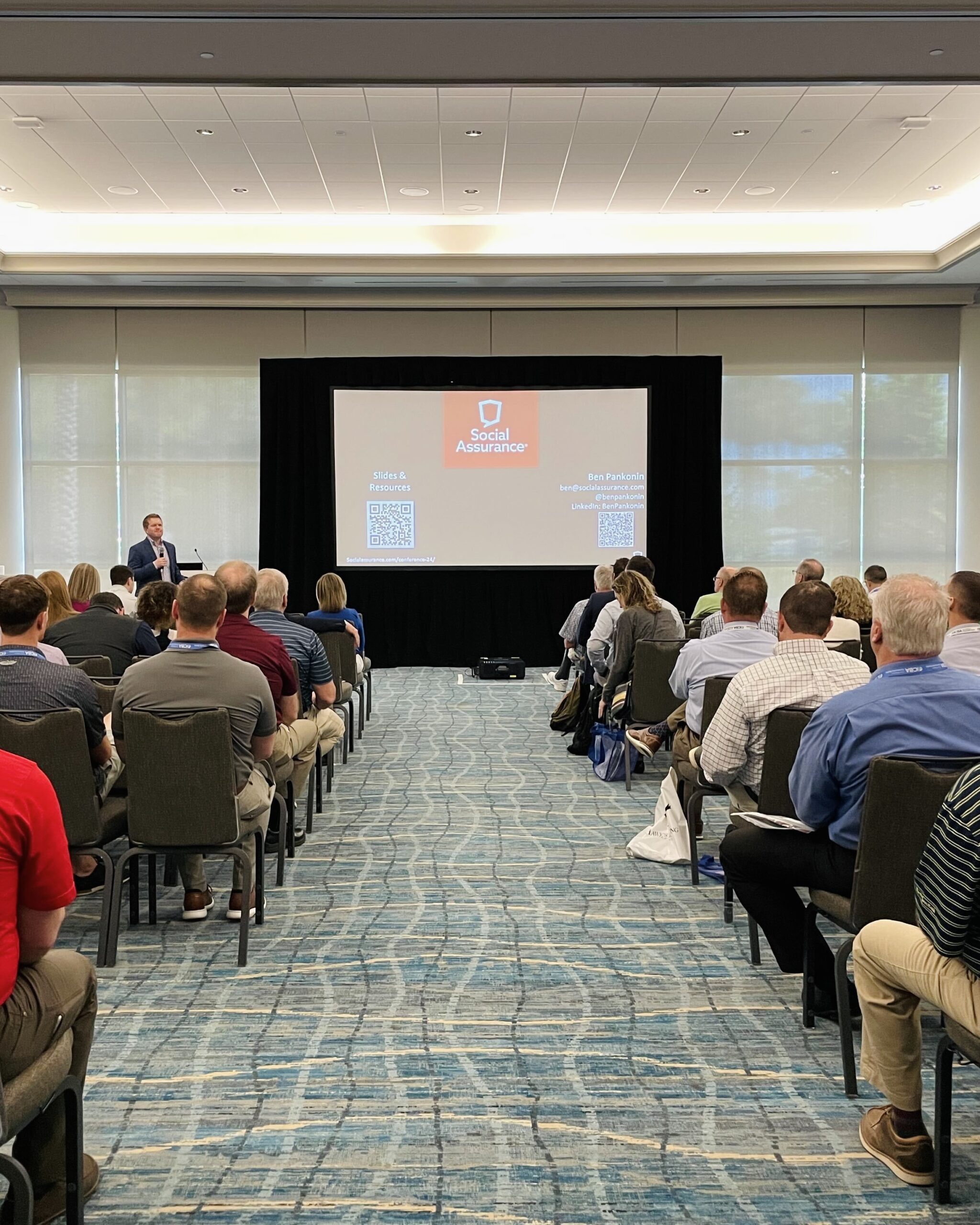 A full conference room during Ben's presentation.