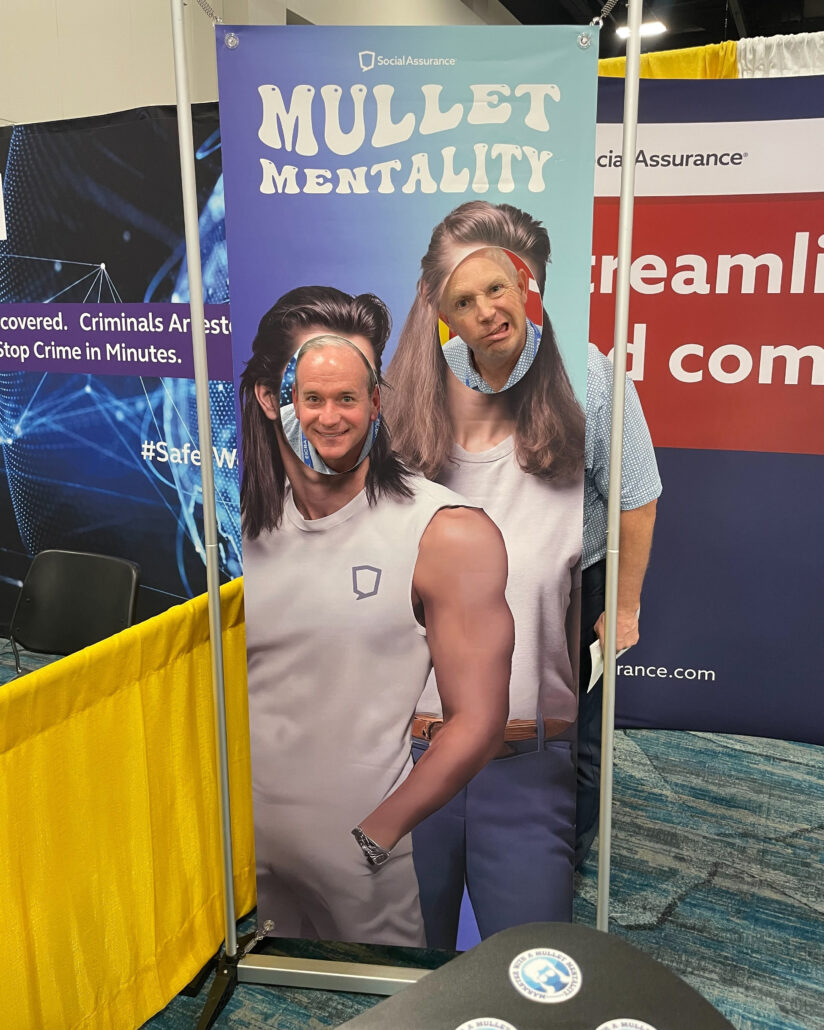 Two men pose at the Social Assurance booth during ICBA Live.